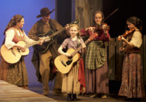 The onstage folk band from a past production of "Tom Sawyer" with Eric on guitar